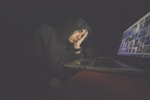 Man Resting in front of laptop